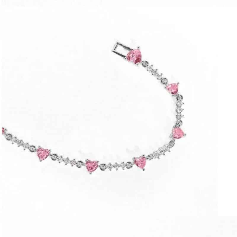 Silver chain bracelet with pink heart charms and rhinestone accents, adjustable clasp