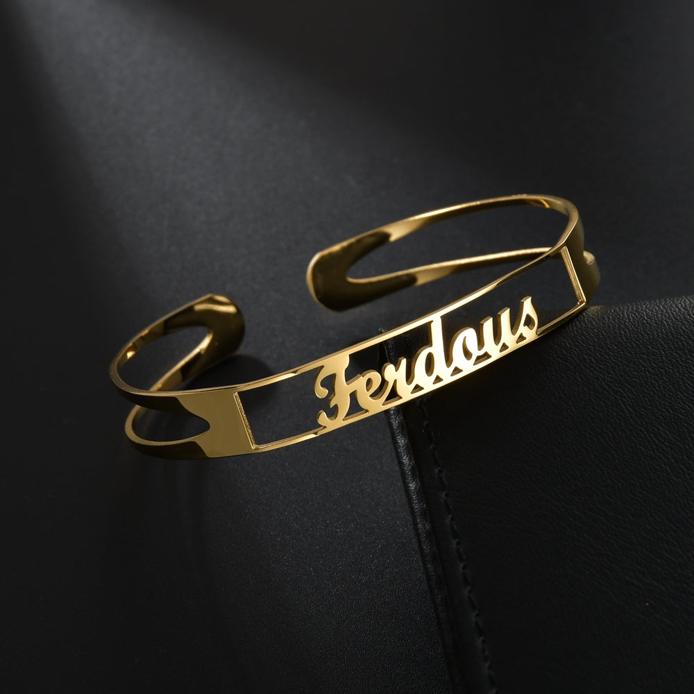 Gold stainless steel open cuff bracelet with engraved cursive name plate