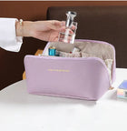 Lavender travel cosmetic bag with open top, side zipper, and interior dividers