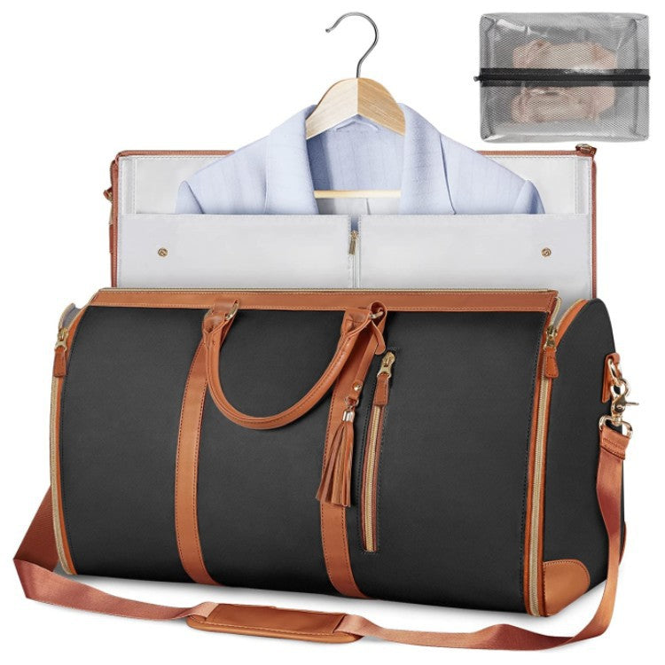 Foldable dark duffle bag with tan trim, zip top, and front pocket with tassel zippers