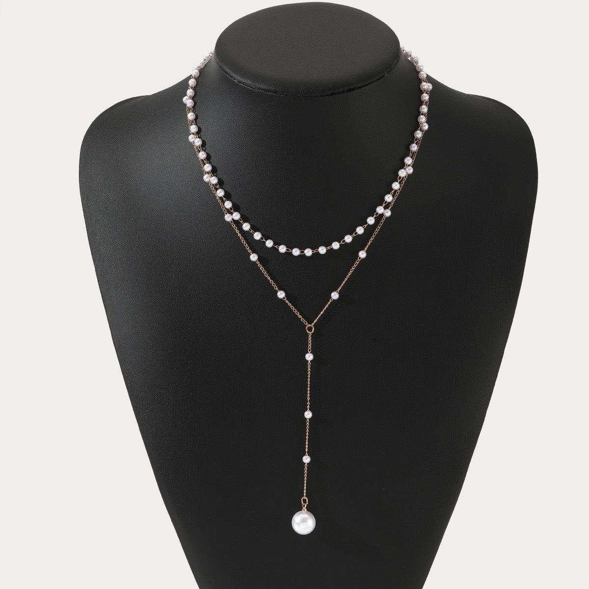 Double-layer pearl necklace with gold-tone chain and layered white pearl strands
