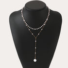 Double-layer pearl necklace with gold-tone chain and layered white pearl strands