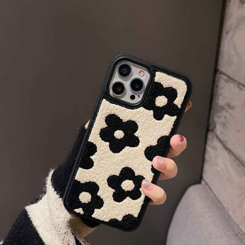 Plush floral iPhone case, cream with black flowers; raised camera opening and textured finish
