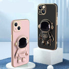 Pink and black phone cases with 3D astronaut design and ring grip