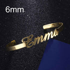 Personalized engraved stainless steel bangle bracelet, gold-tone with cursive name engraving