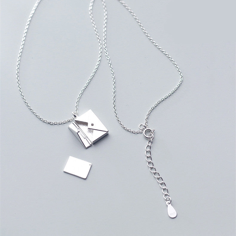 Silver envelope pendant necklace with chain links and small charm details