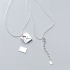 Silver envelope pendant necklace with chain links and small charm details