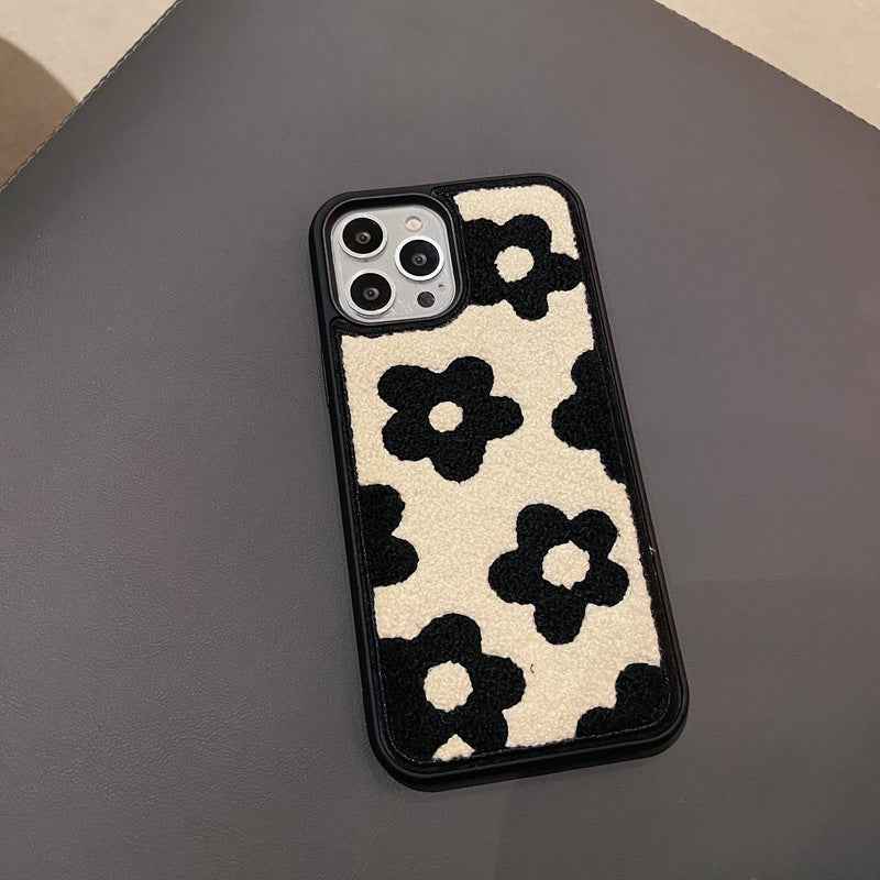 Plush floral iPhone case, cream and black flower pattern; raised camera cutouts on back
