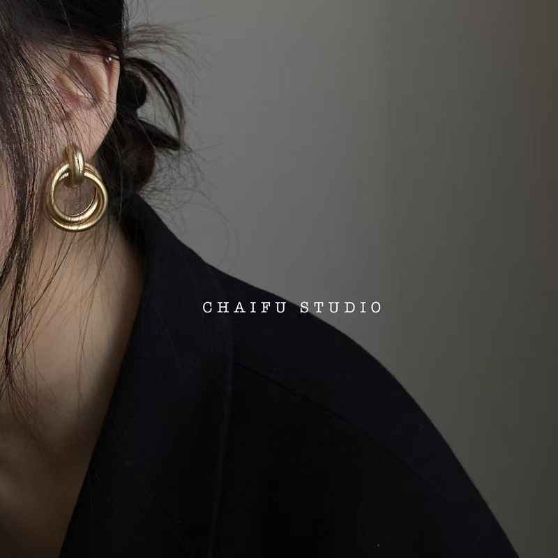 Gold baroque hoop earrings featuring layered ring design