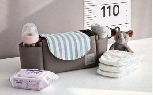 Grey hanging nappy organizer with light-blue striped pocket and side compartments