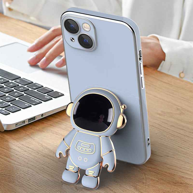 Light blue phone case with 3D astronaut charm and raised camera cutouts