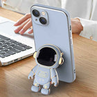 Light blue phone case with 3D astronaut charm and raised camera cutouts