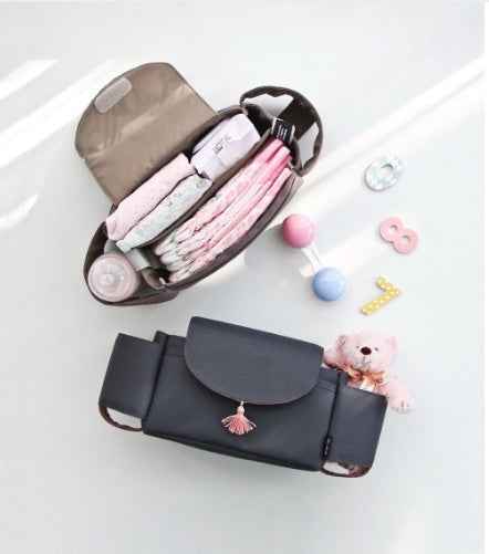 Dark stroller nappy organizer with beige insert and multiple zip pouches