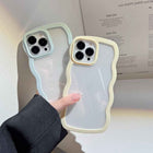Pair of transparent silicone iPhone cases with pastel wavy border trim and camera cutouts