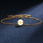 Gold-tone initial bracelet with round charm letter Q