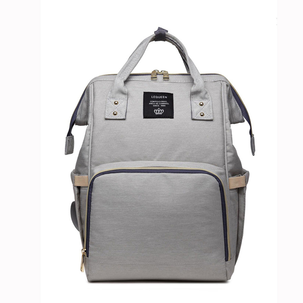 Maternity diaper bag, light gray with navy trim and front zipper pocket, top carry handles