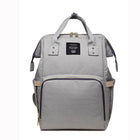 Maternity diaper bag, light gray with navy trim and front zipper pocket, top carry handles