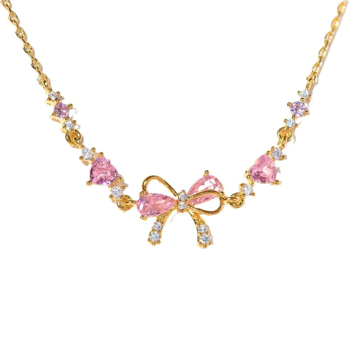 Gold-tone rhinestone bow bracelet with pink heart stones and small clear accents