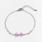 Silver chain bracelet with two pink heart-shaped rhinestone charms, adjustable clasp