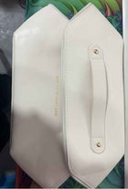 White travel cosmetic bag with side zipper pocket and gold hardware accents
