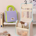 Lavender and mint hanging makeup bags, one open with clear mesh compartments