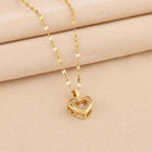 Gold heart pendant necklace with small heart charm featuring clear stones