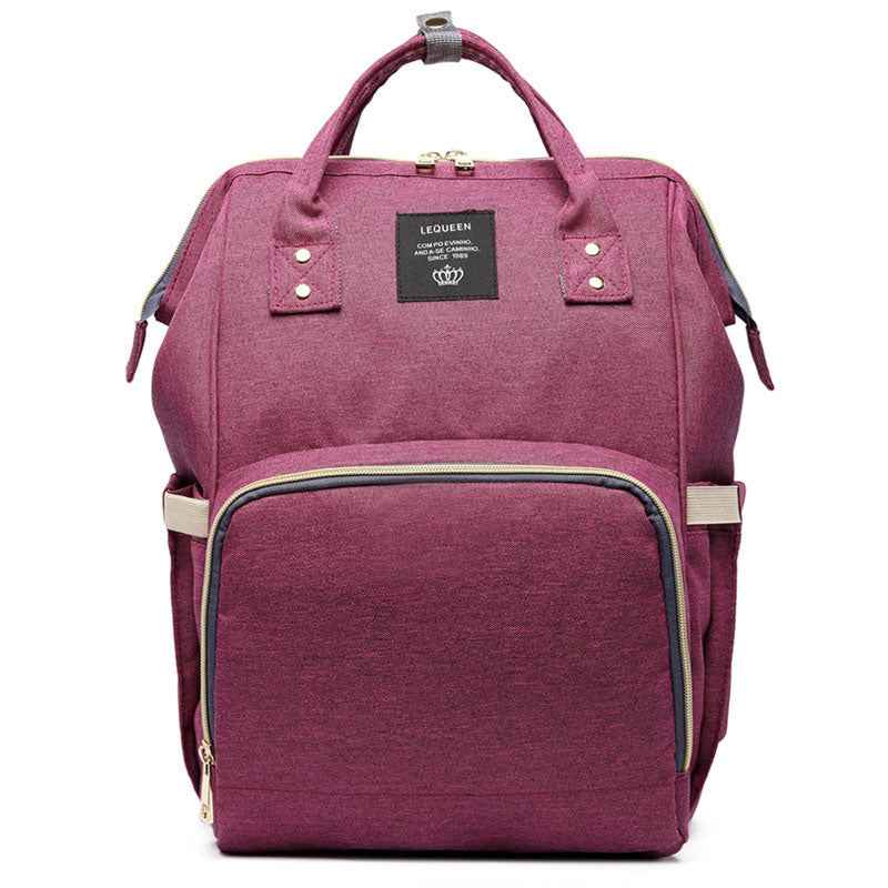 Burgundy pink maternity diaper bag with front zip pocket and top carry handles