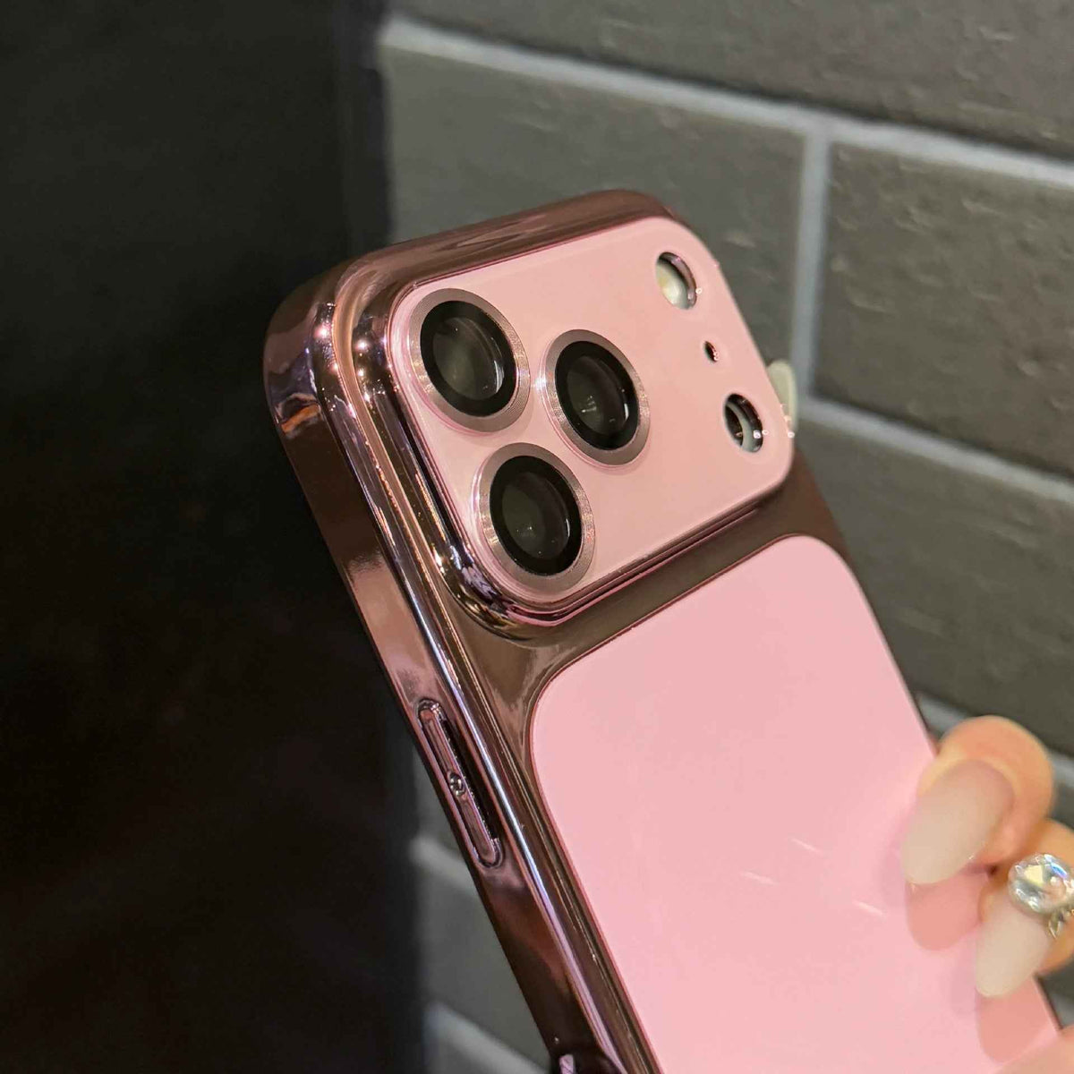 Rose-pink phone case with raised camera lens guard and cutouts for ports