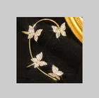 Gold butterfly earrings with hoop frame and sparkling butterfly accents on a black background