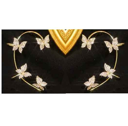 Gold butterfly earrings with hoop frame and sparkling butterfly accents on a black surface