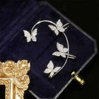 Silver butterfly earrings with a hoop frame and butterfly studs, shown in a jewelry box
