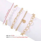 Gold-tone pearl bracelet set with oval links, bead chain, and small 'love' charm