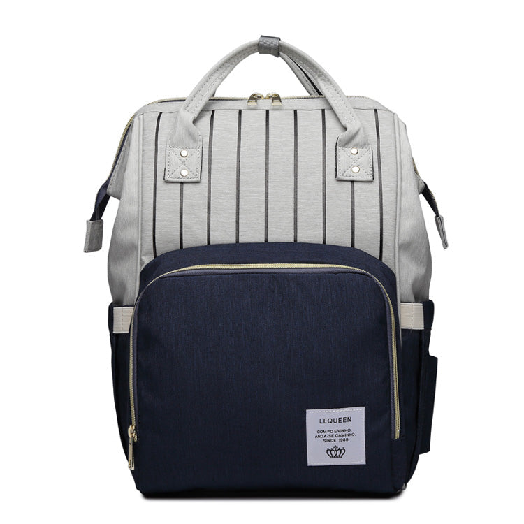 Light gray and navy maternity diaper bag with striped top and front zip pocket