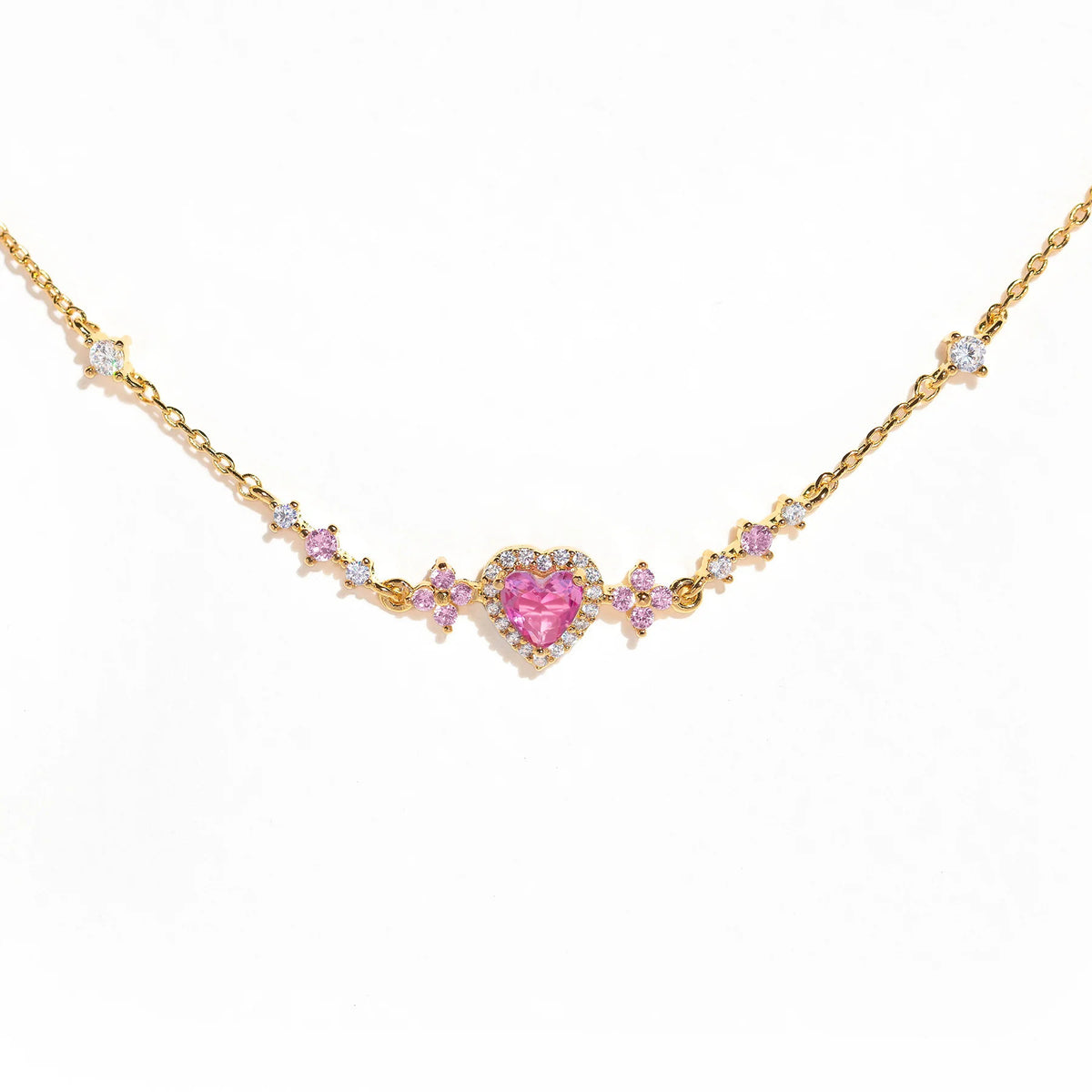 Gold chain bracelet with pink heart center and small pink rhinestone links