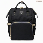 Black diaper backpack with front zip compartment, beige piping, and top carry handles
