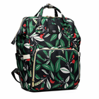 Green and black leaf-print diaper backpack with front zip pocket and top handles
