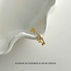 Gold-tone open bow link ring on stand, adjustable clasp and chain detail