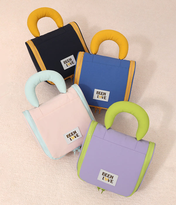 Set of hanging travel makeup bags in blue, black, pink, and purple