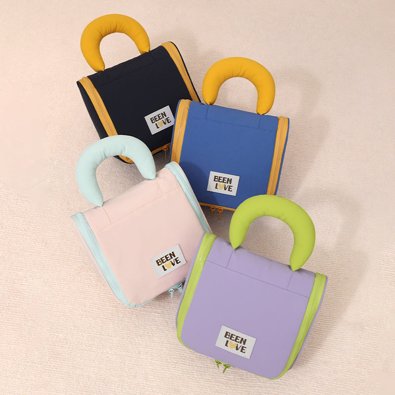 Set of hanging travel makeup bags in blue, black, pink, and purple