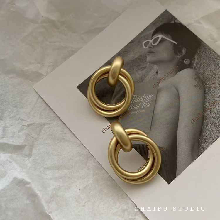 Gold baroque statement earrings with stacked circular metal links