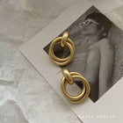 Gold baroque statement earrings with stacked circular metal links