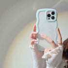 Light blue silicone iPhone case with wavy candy border and raised camera cutouts