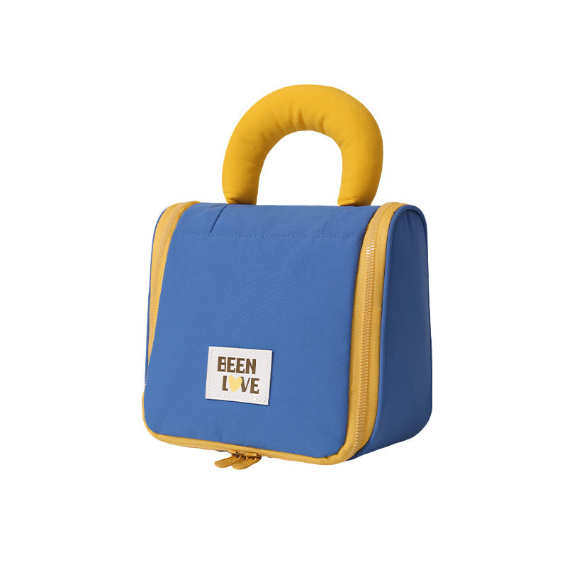 Blue hanging makeup bag with mustard handle and zip closure