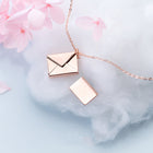 Rose gold envelope pendant necklace with open-letter style charm