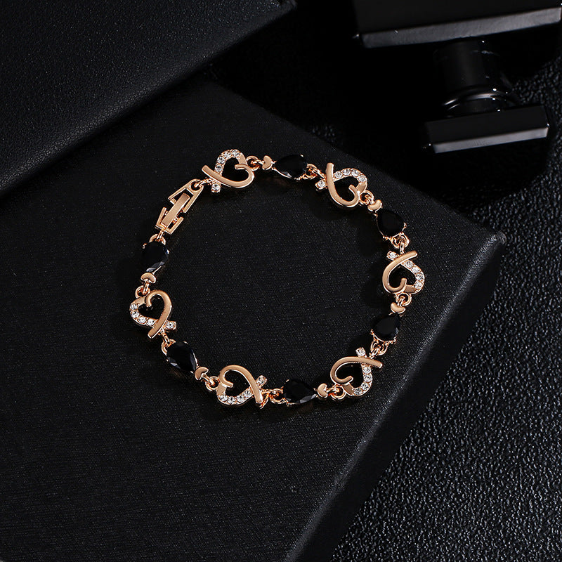 Rhinestone heart charm bracelet with black stones and heart links with crystal accents