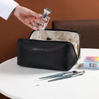 Black travel cosmetic bag with front zipper, open top, and inner compartments