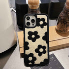 Plush floral iPhone case, cream with black flowers and orange accents; raised camera opening