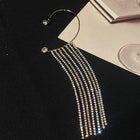 Long silver tassel earrings with rhinestone rows and hoop ear hooks