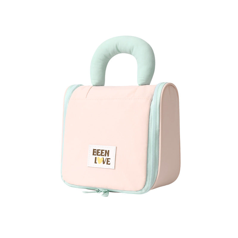 Light pink hanging makeup bag with mint handle and zip side panel