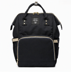 Black diaper backpack with beige trim, front zip pocket, and buttoned side straps